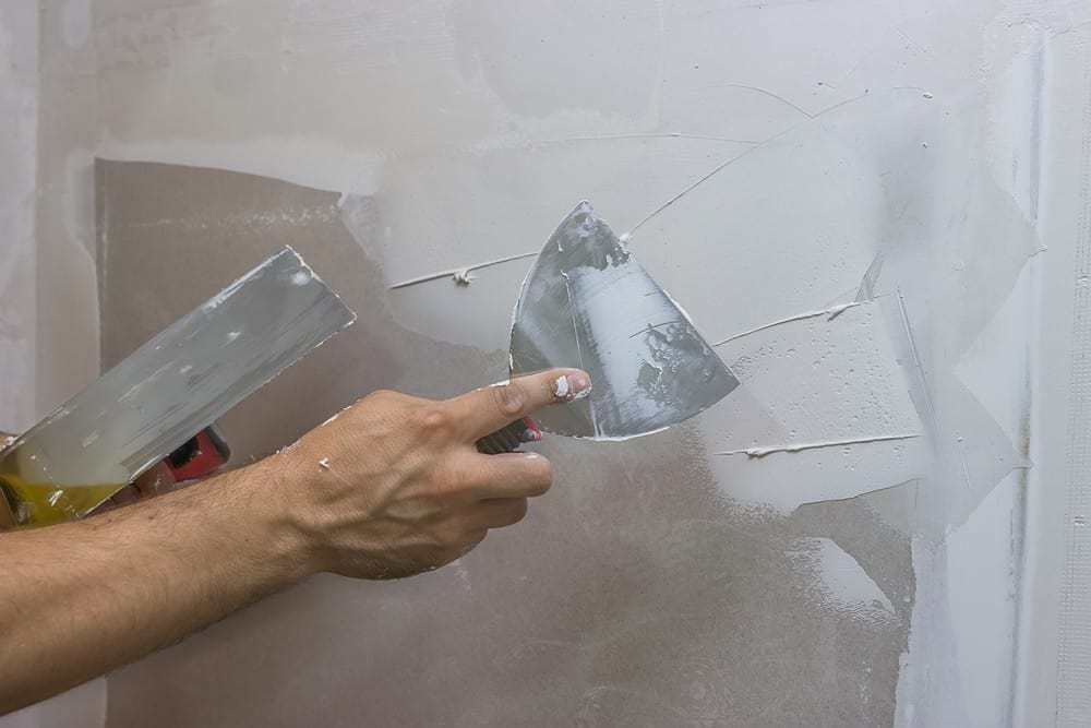 applying plaster to wall