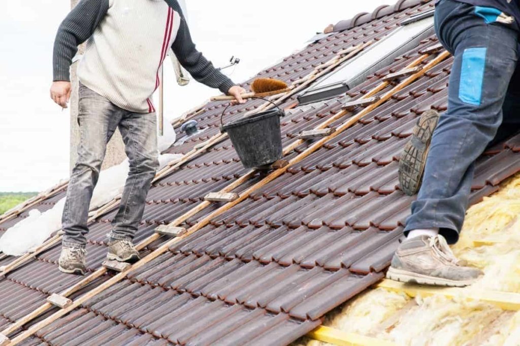 men replacing a roof