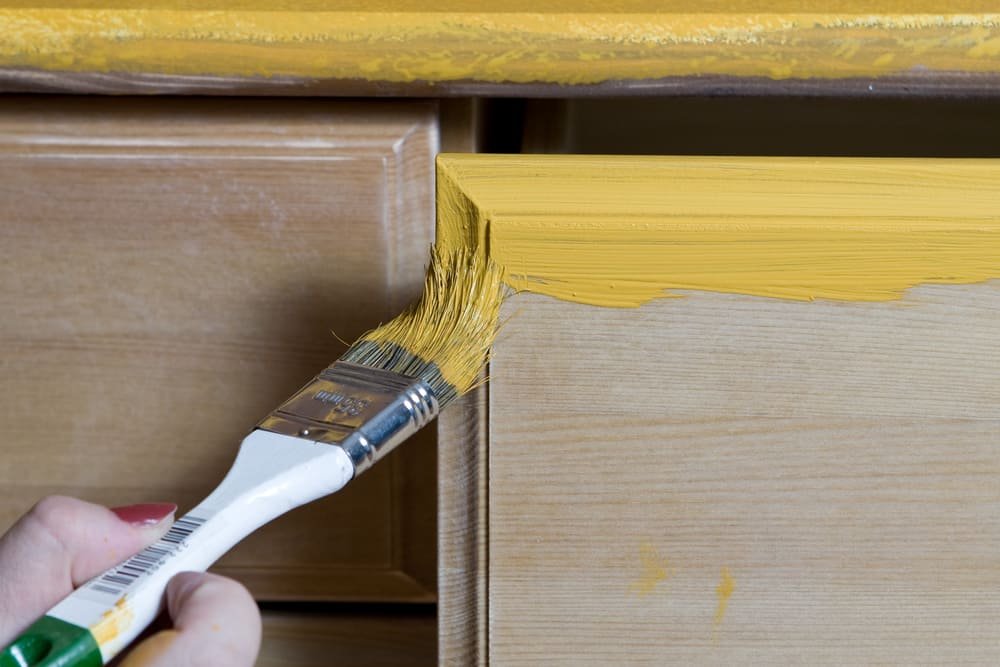woman painting woodwork