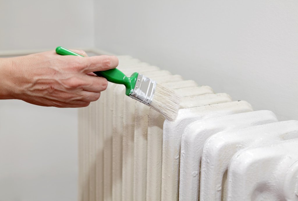 painting a radiator with a paint brush