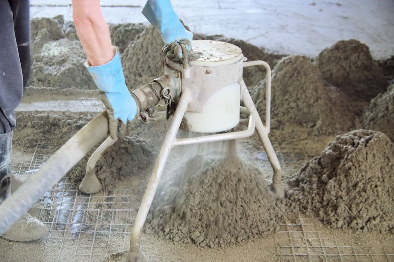 worker preparing concrete for screeding