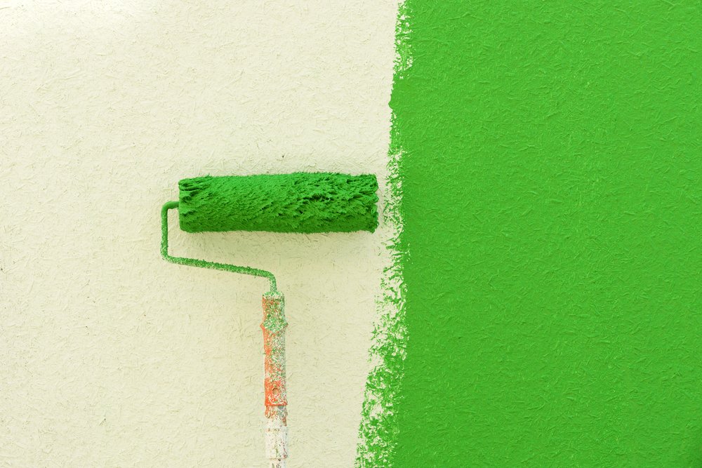 white and green colored wall painted with roller