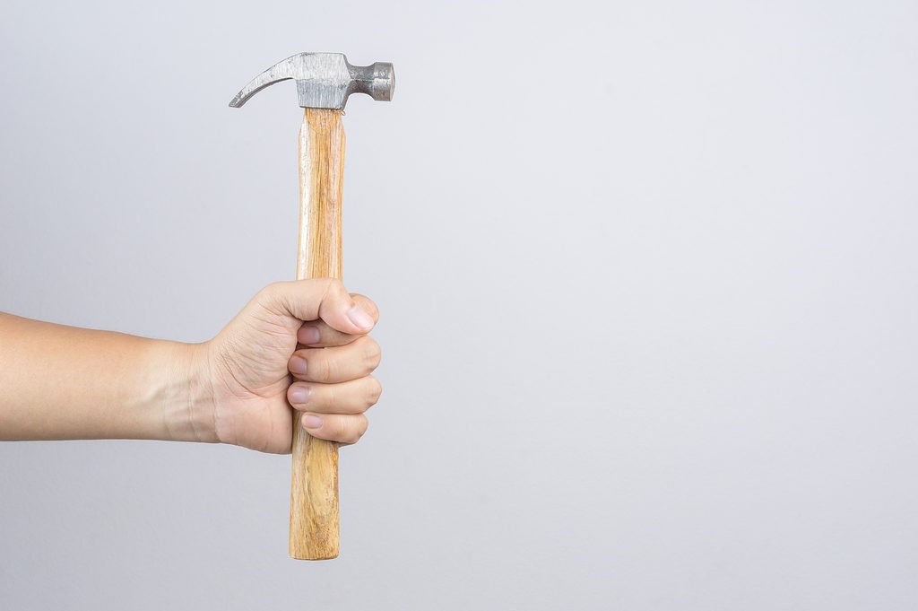 hand holding claw hammer
