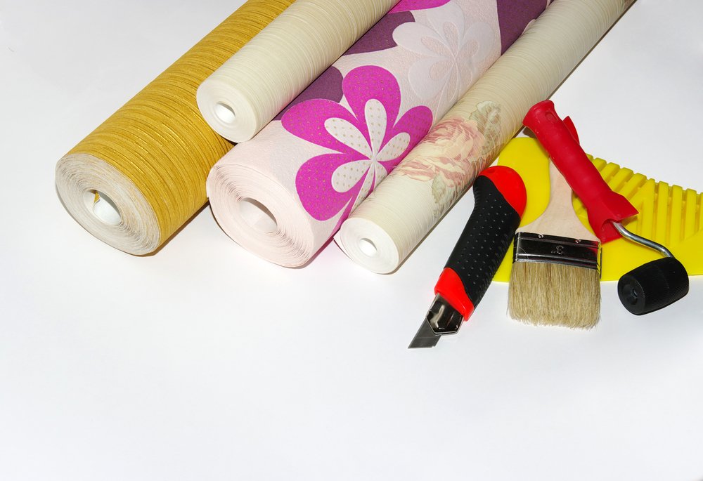 roll of wallpapers and wallpapering tools