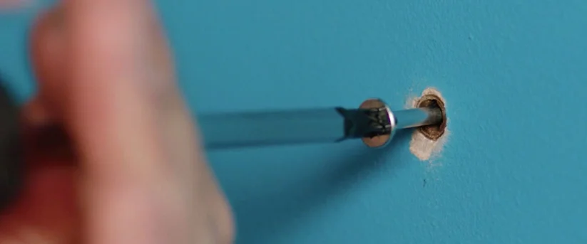 inserting screw on the wall