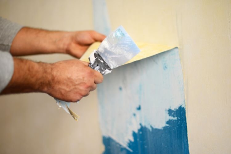 man removing wallpaper