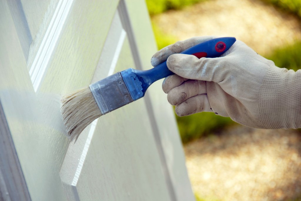 painting door using a paint brush
