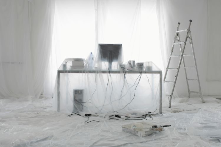 room objects covered with plastic sheets