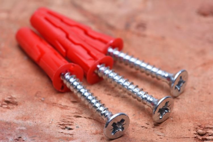screws with red wall plugs