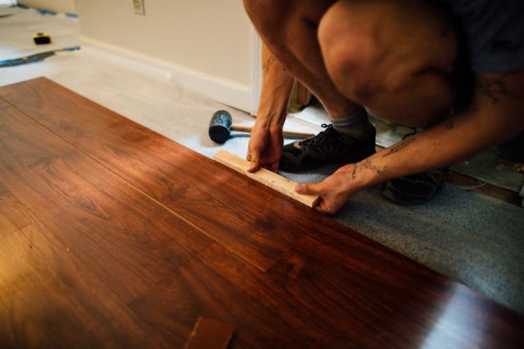 carpenter laying wooden floors