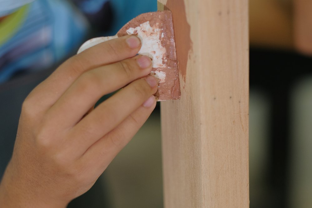 carpenter applying wood filler