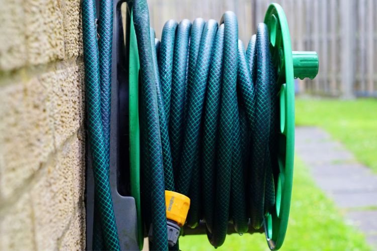coiled up hose hanging on a wall