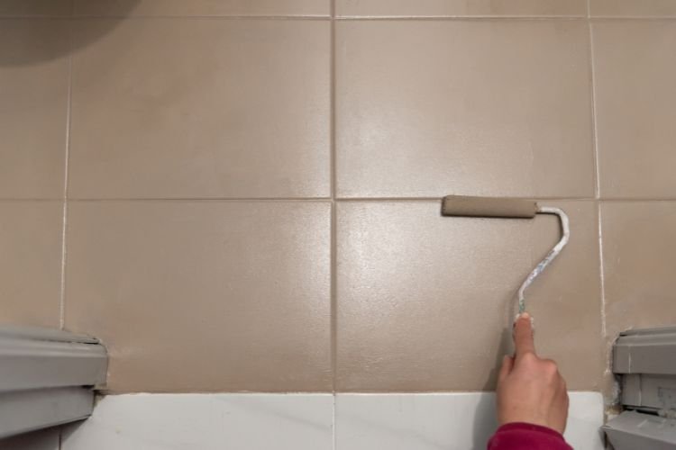 painter painting bathroom tiles