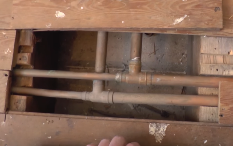 pipes under wooden floor